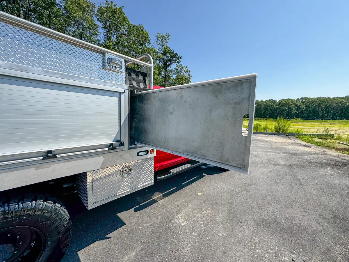 Right-side long storage door fully open showing shelf bay and floor.